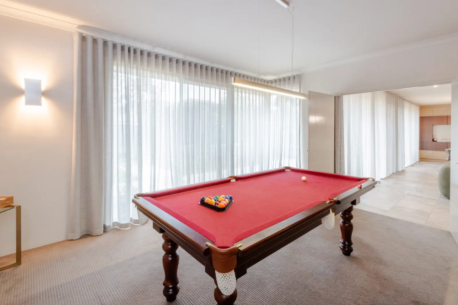 Full-height sheer curtains across a wide living area