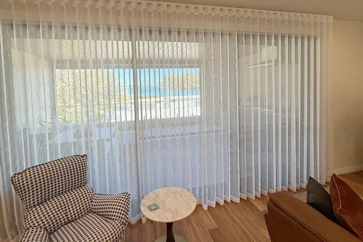 Floor-length sheer curtains filtering daylight in a Perth living room.