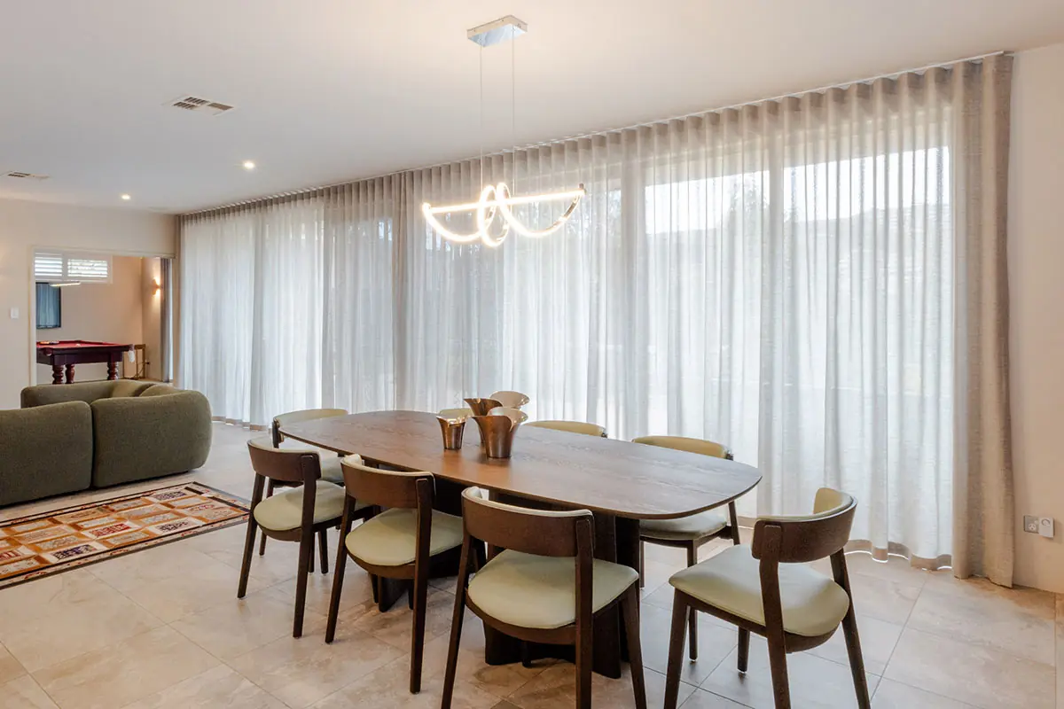 Floor-to-ceiling sheer curtains across a Perth living and dining area